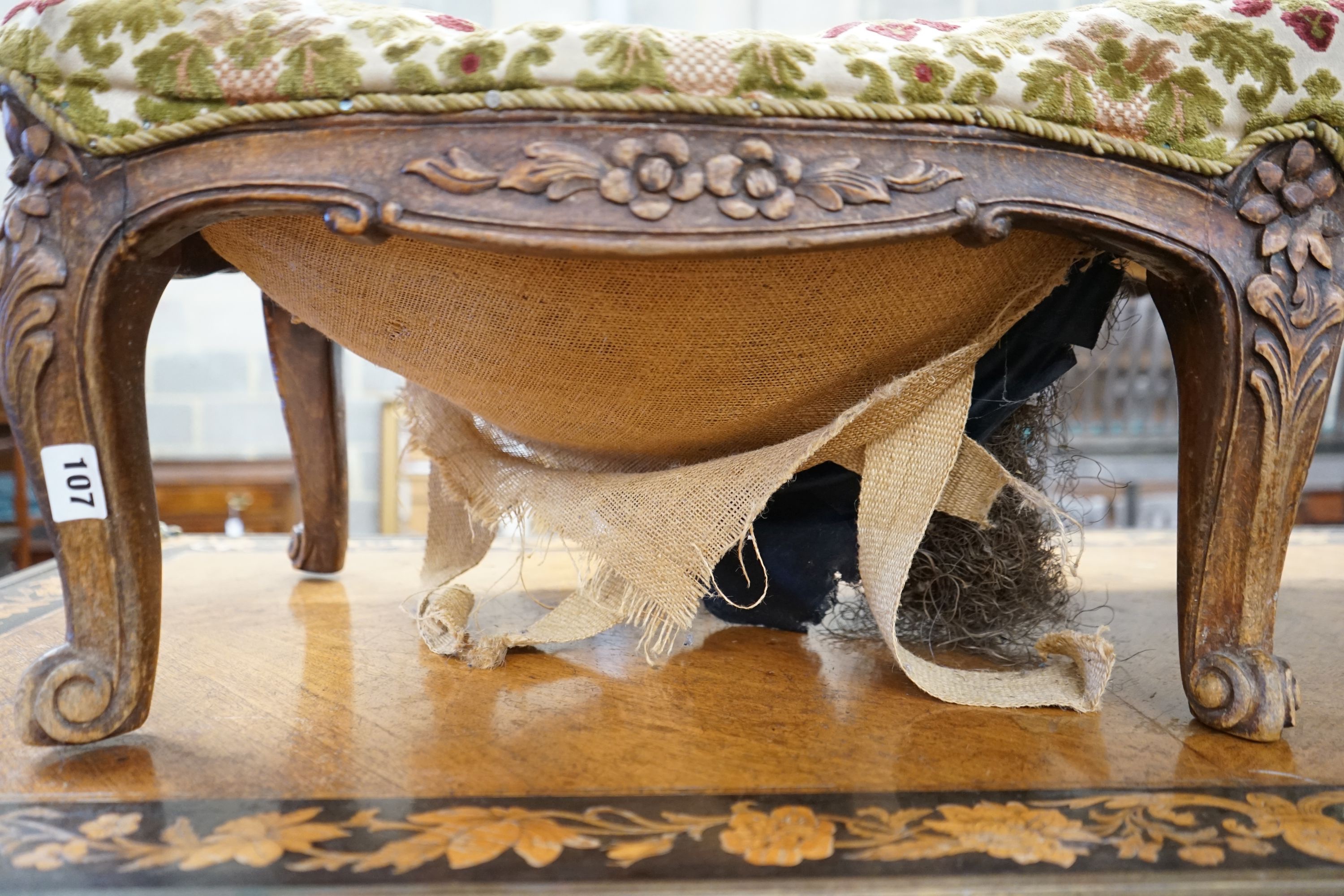 A Victorian walnut fender stool requiring re-upholstery, length 108cm, depth 40cm, height 33cm